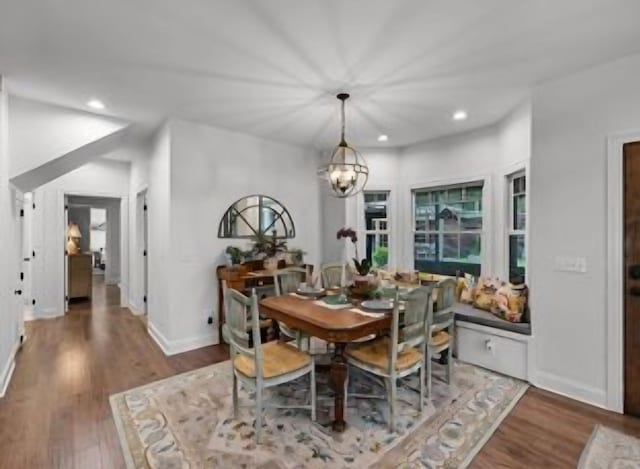 dining area featuring dark hardwood / wood-style flooring and a notable chandelier