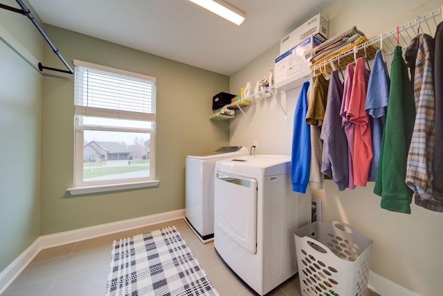 washroom featuring independent washer and dryer and light tile patterned floors