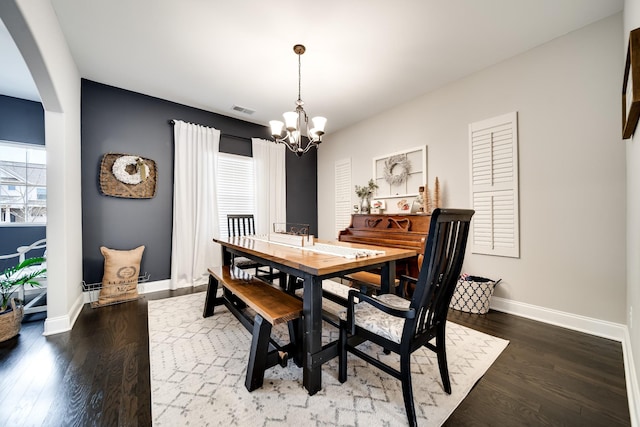 dining room featuring a notable chandelier and dark hardwood / wood-style flooring