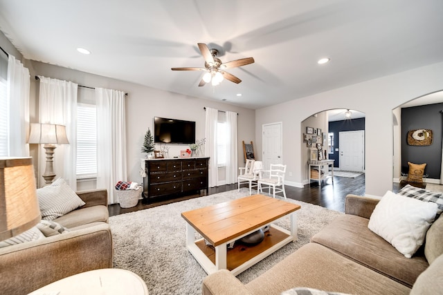 living room with ceiling fan, a healthy amount of sunlight, and dark hardwood / wood-style floors