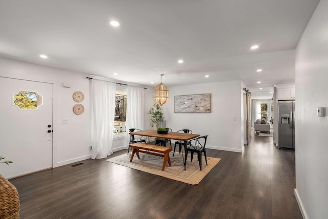 dining space featuring dark hardwood / wood-style floors