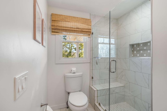 bathroom featuring an enclosed shower and toilet