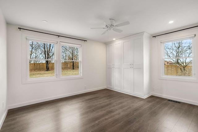 unfurnished bedroom with dark hardwood / wood-style floors, a closet, and ceiling fan