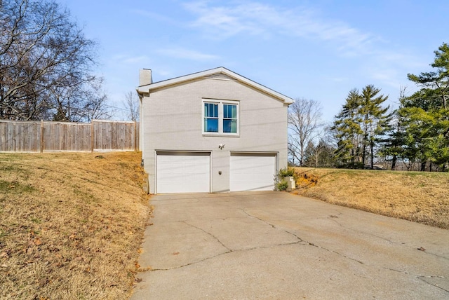 view of side of home featuring a garage and a yard