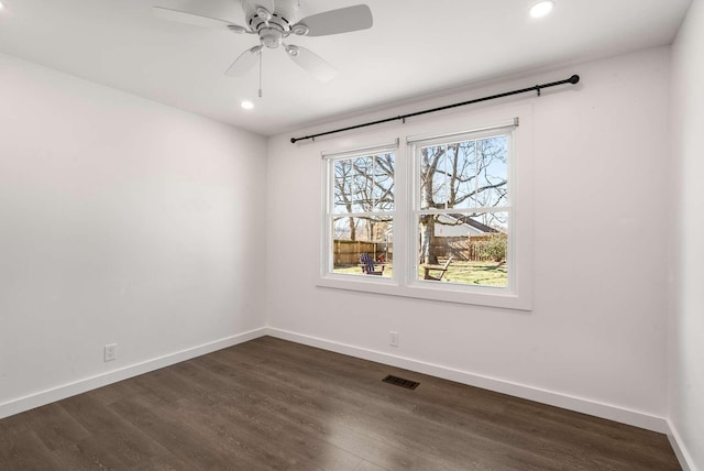 unfurnished room featuring dark hardwood / wood-style flooring and ceiling fan