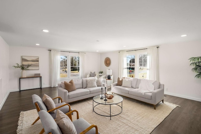 living room featuring plenty of natural light and dark hardwood / wood-style floors