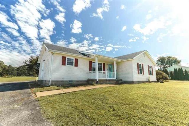 ranch-style home with a porch and a front yard