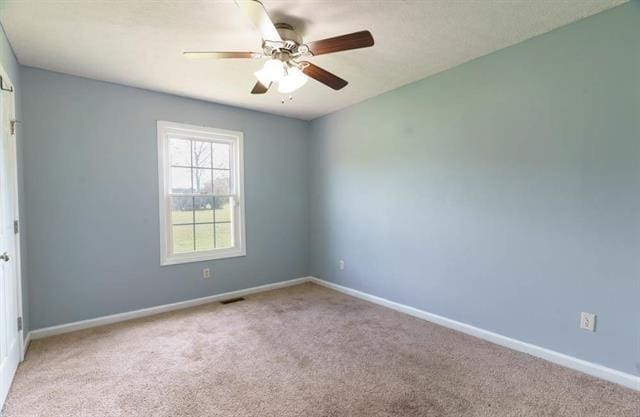 carpeted empty room with ceiling fan