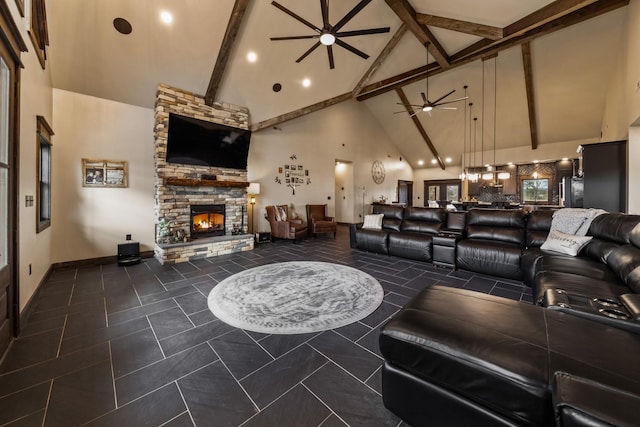 living room featuring beamed ceiling, ceiling fan, a fireplace, and high vaulted ceiling