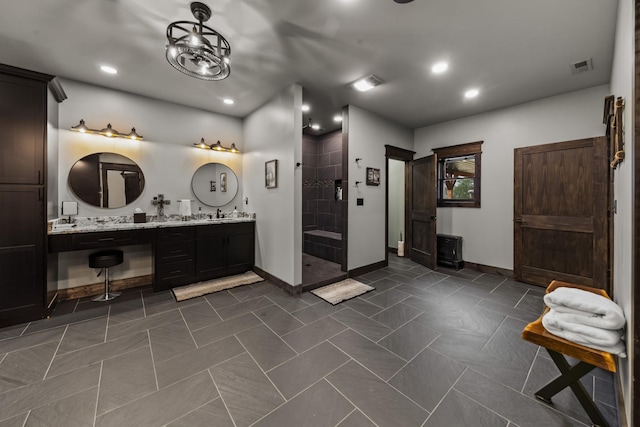 bathroom featuring vanity and a shower