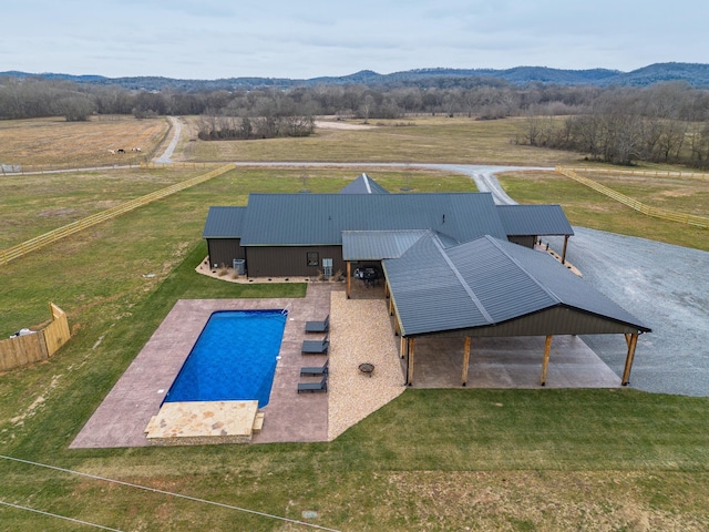 view of pool with a mountain view and a rural view