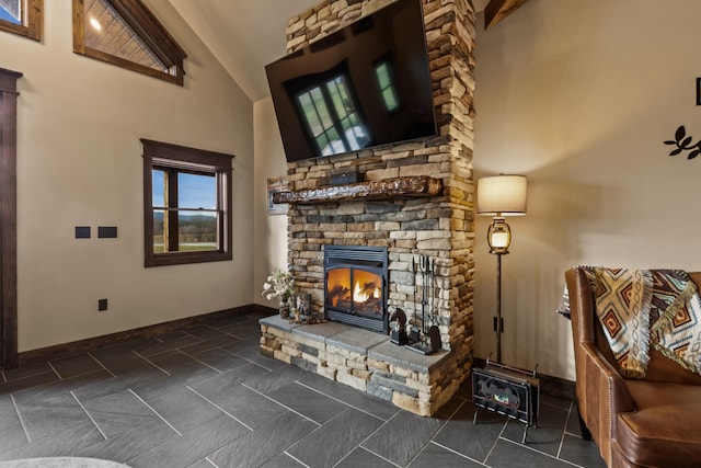 living room with a stone fireplace and vaulted ceiling