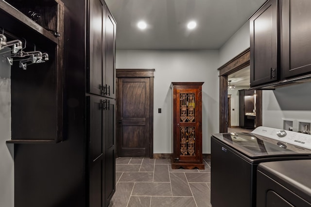 laundry room with washer and dryer and cabinets