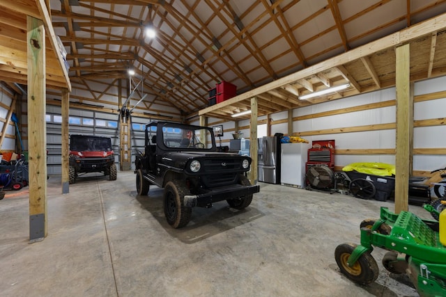 garage with stainless steel fridge and stainless steel fridge with ice dispenser