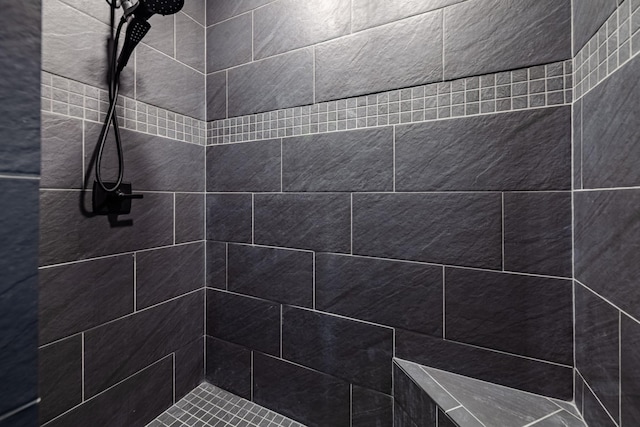 bathroom with tiled shower