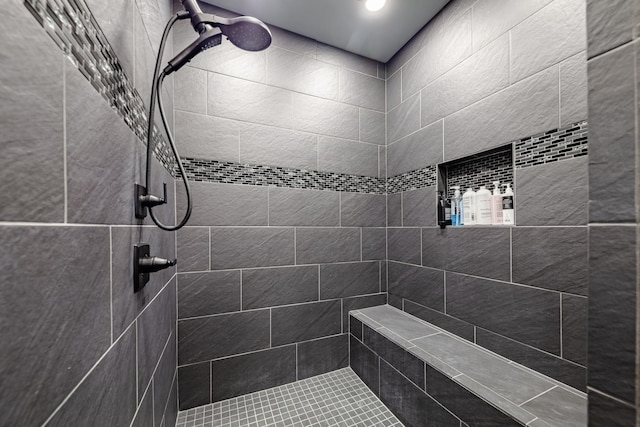 bathroom with a tile shower