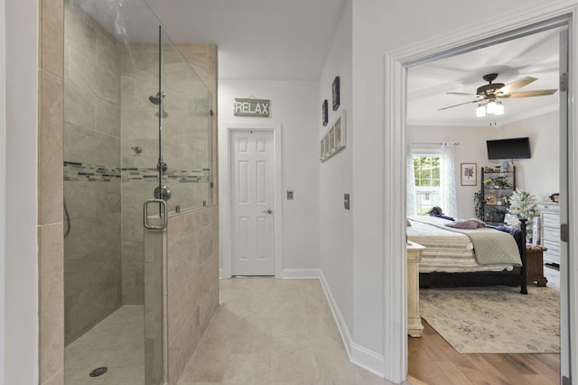 bathroom featuring a shower with door, crown molding, hardwood / wood-style floors, and ceiling fan