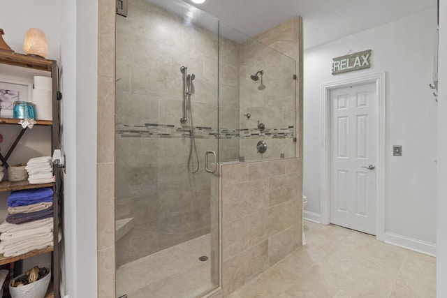 bathroom featuring a shower with door