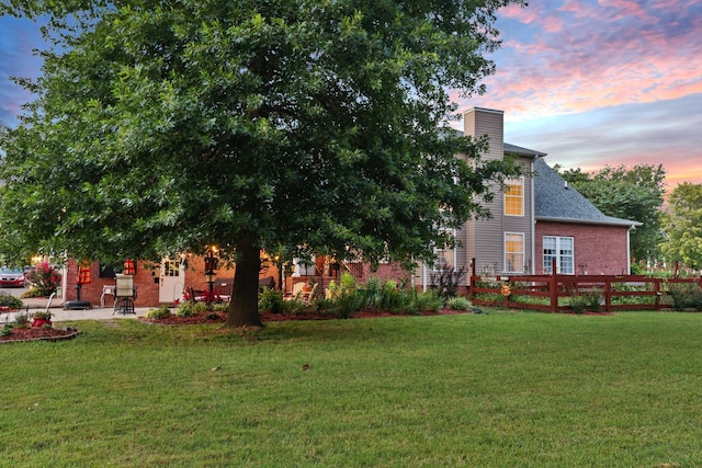 yard at dusk with a patio area