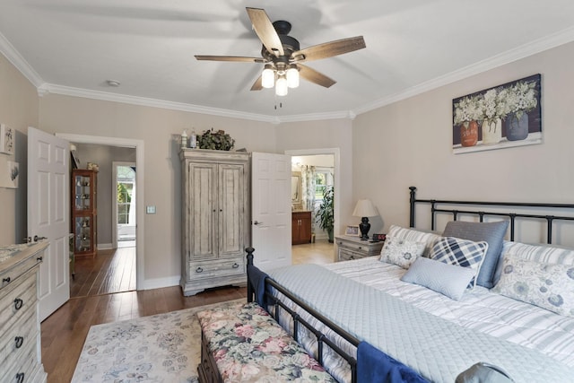 bedroom with crown molding, dark wood-type flooring, ceiling fan, and ensuite bath