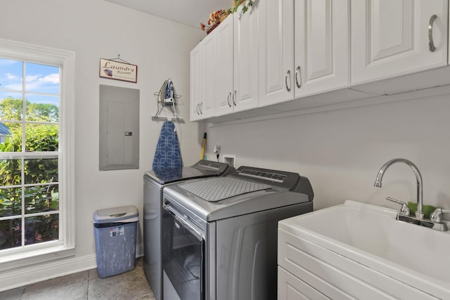 washroom with sink, tile patterned flooring, electric panel, cabinets, and separate washer and dryer