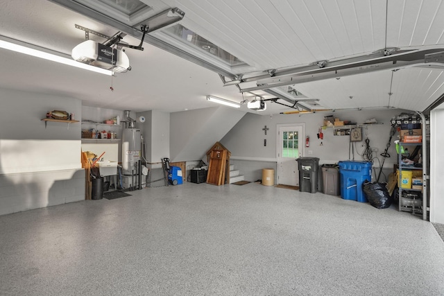 garage featuring a garage door opener, sink, and gas water heater