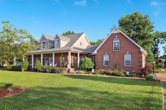 cape cod-style house featuring a porch and a front lawn