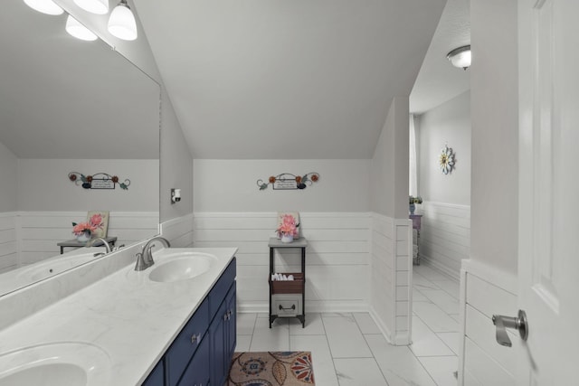 bathroom with vanity and lofted ceiling