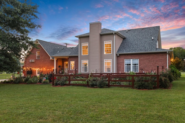 back house at dusk with a yard