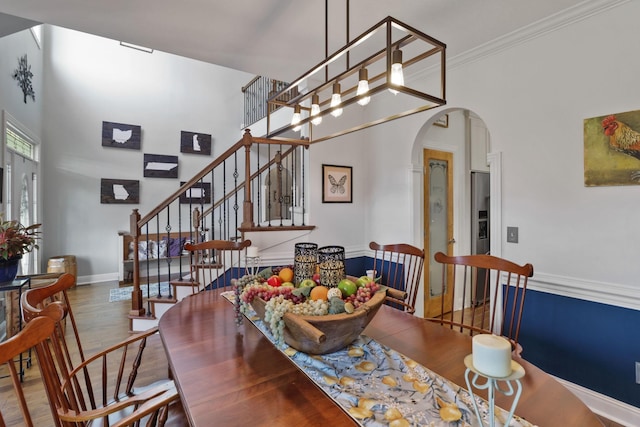 dining area with hardwood / wood-style flooring and crown molding