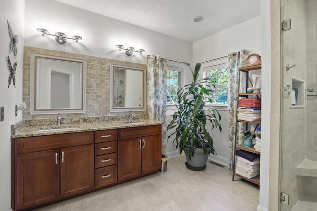 bathroom with vanity and a shower with shower door