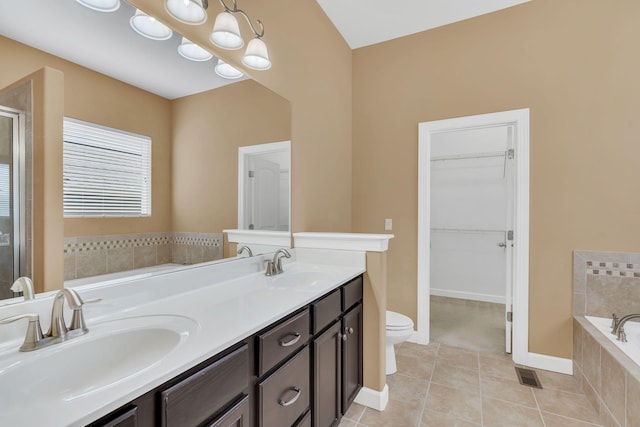 full bathroom with shower with separate bathtub, tile patterned flooring, vanity, toilet, and an inviting chandelier