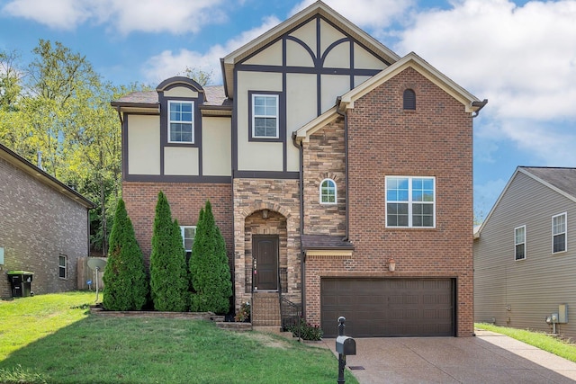 english style home featuring a garage and a front yard