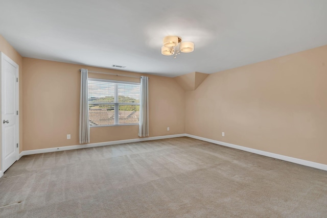 spare room with light colored carpet