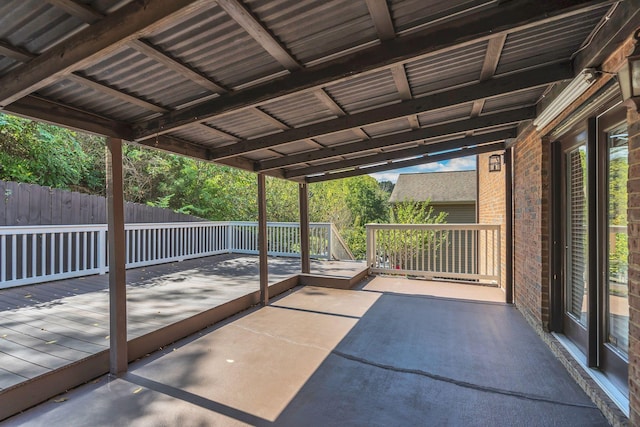 unfurnished sunroom featuring vaulted ceiling