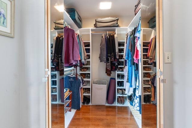 walk in closet featuring wood finished floors