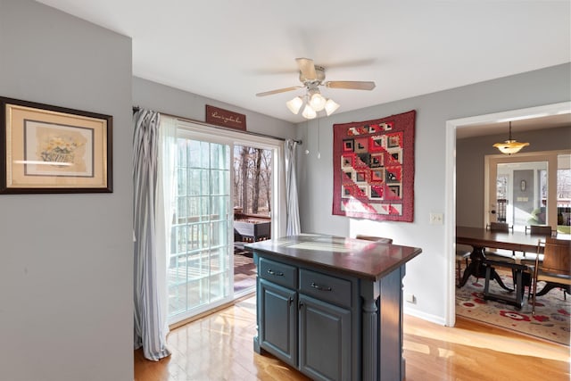 kitchen featuring light hardwood / wood-style floors, ceiling fan, and a kitchen island