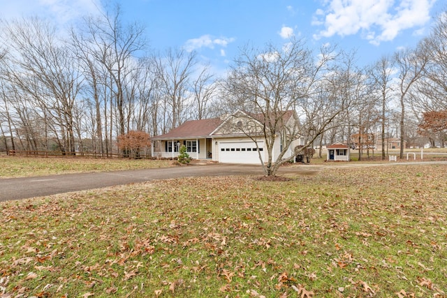 view of front facade featuring an attached garage, a front lawn, and aphalt driveway