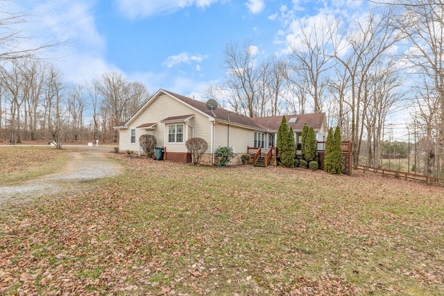 view of property exterior with a lawn and driveway