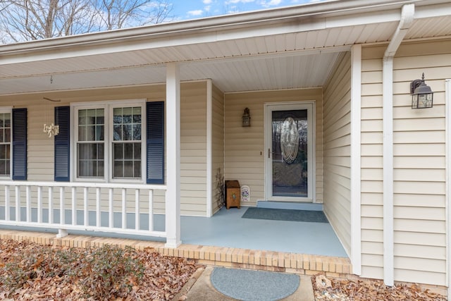 view of exterior entry with a porch