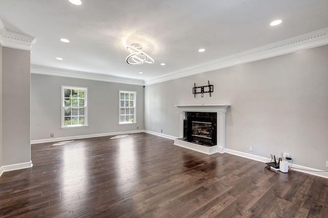 unfurnished living room featuring crown molding, dark wood-type flooring, and a premium fireplace