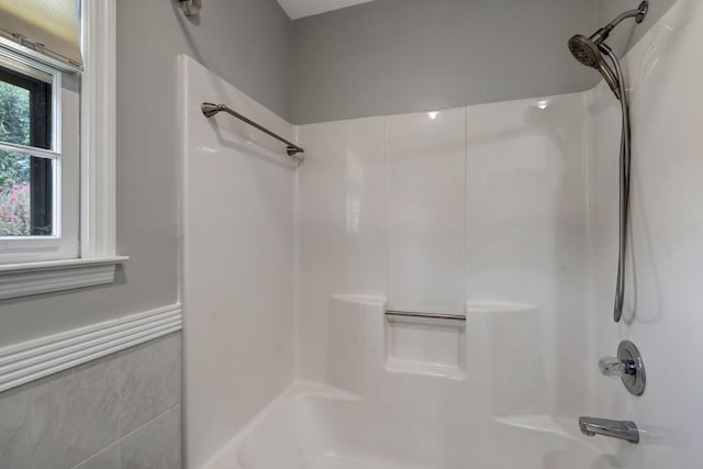 bathroom with bathing tub / shower combination