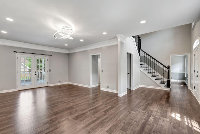 unfurnished living room with french doors, dark hardwood / wood-style floors, and crown molding