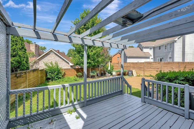 wooden terrace with a pergola and a lawn