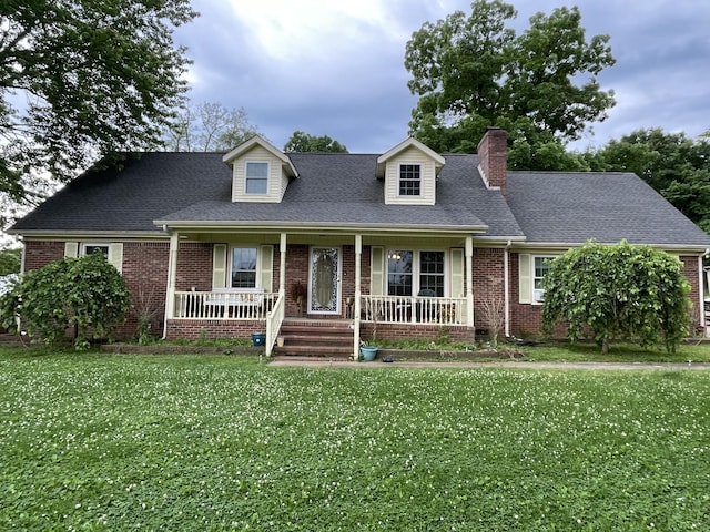 cape cod home with a front lawn and a porch