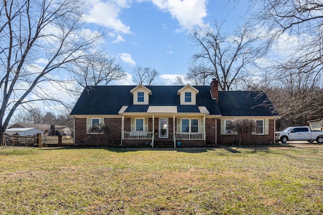 cape cod home featuring a front yard and a porch