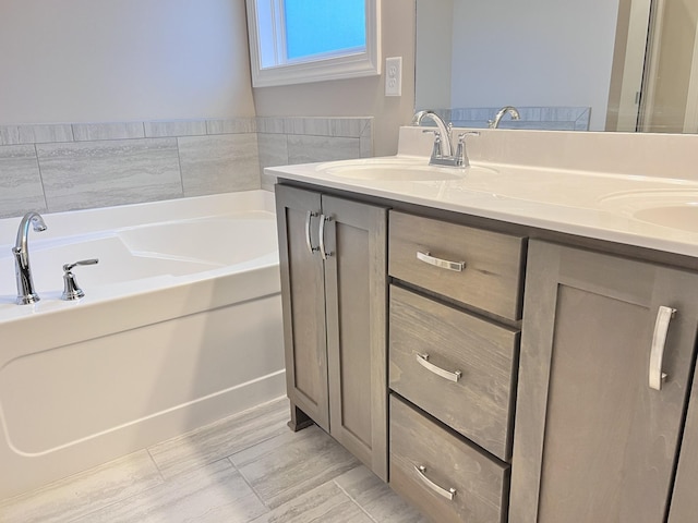 bathroom featuring vanity and a tub to relax in