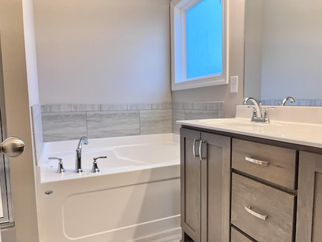 bathroom with vanity and a bathing tub