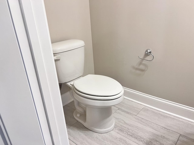 bathroom featuring toilet and tile patterned flooring