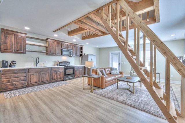 living room featuring sink and light hardwood / wood-style floors